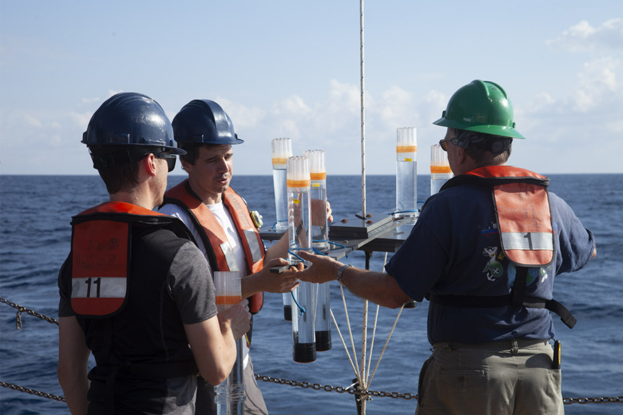 Researchers on the NOAA ship Nancy Foster with a sediment trap to collect sinking particles and carbon. (Courtesy of Michael Stukel)