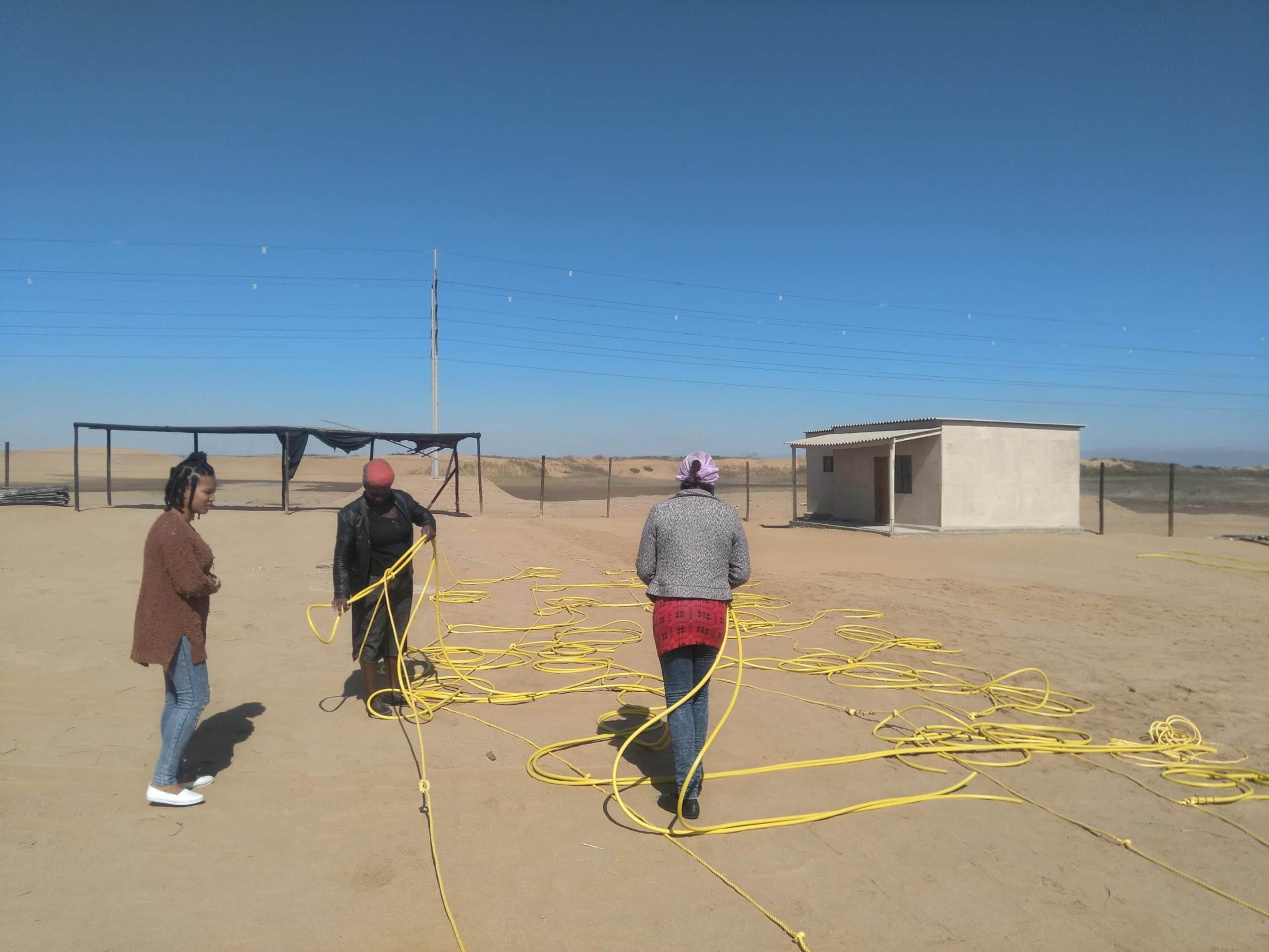 Member of meme Iitumbapo womens group building bird scaring lines two c Titus Shaanika