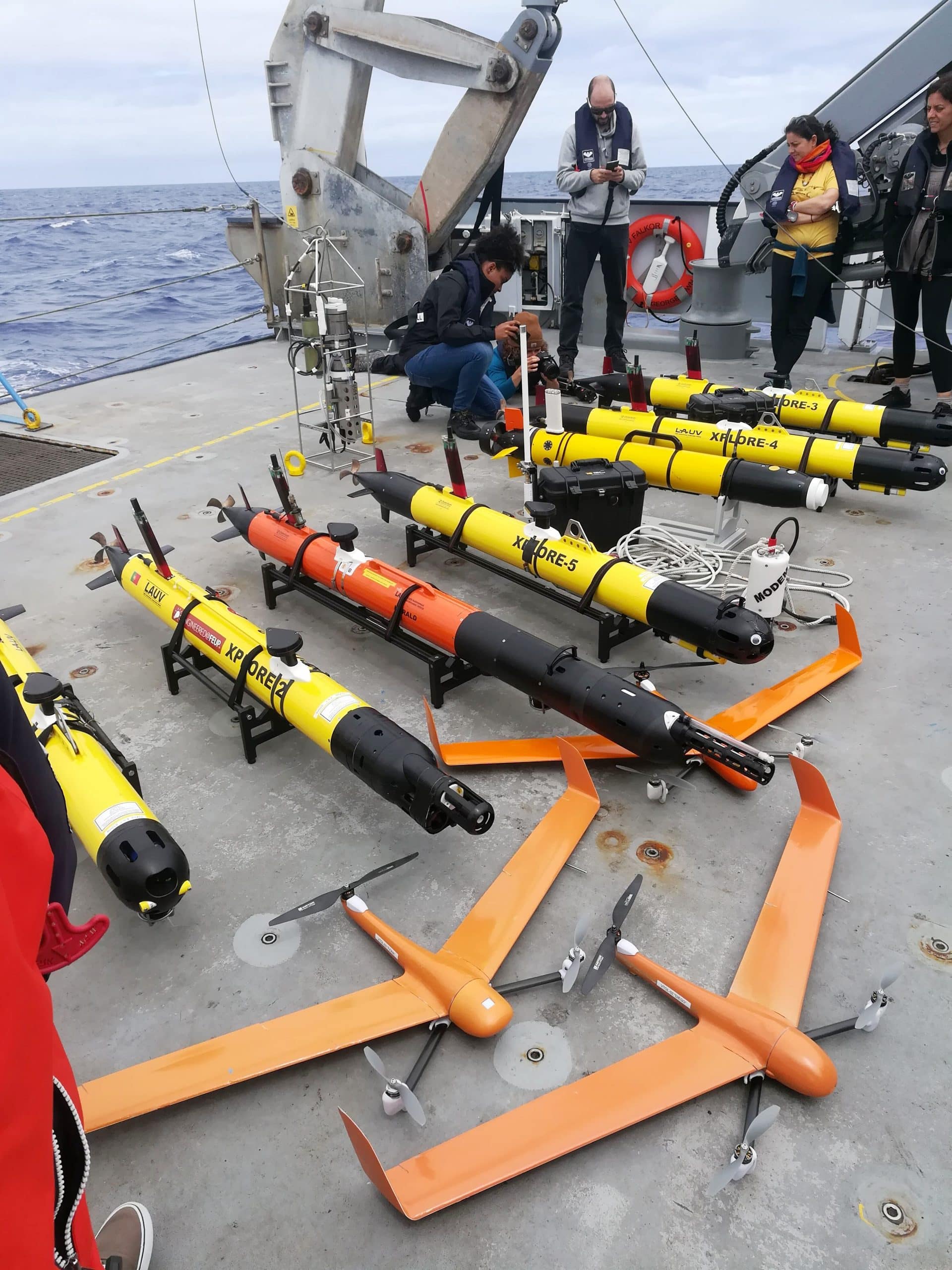 The autonomous vehicles - aerial and underwater - utilized by the Ocean Robots Team line the aft deck of R/V Falkor.