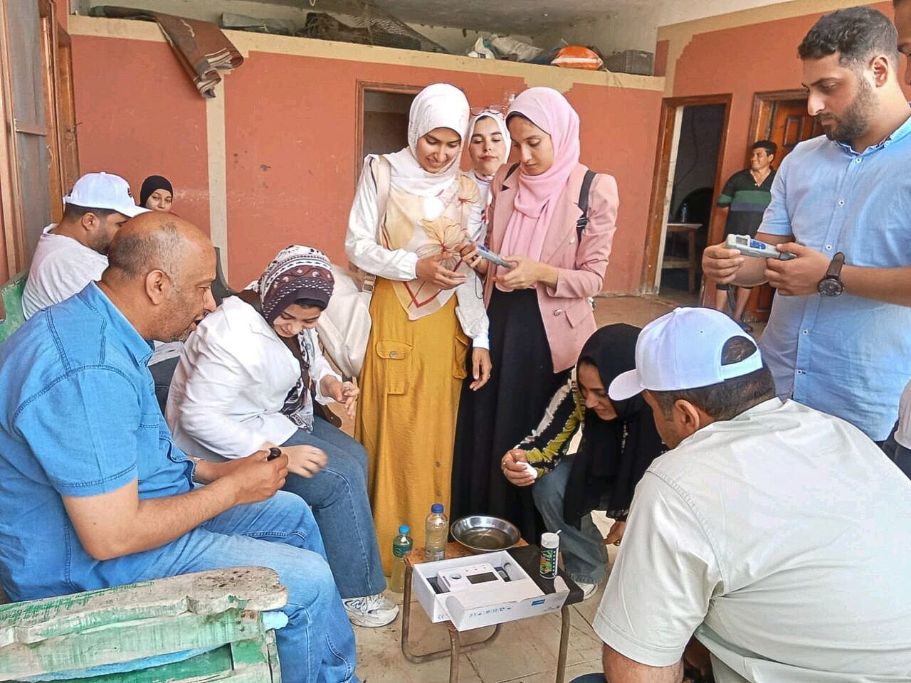 2.A group of trainees practicing assessment procedure on an Egyptian tilapia farm