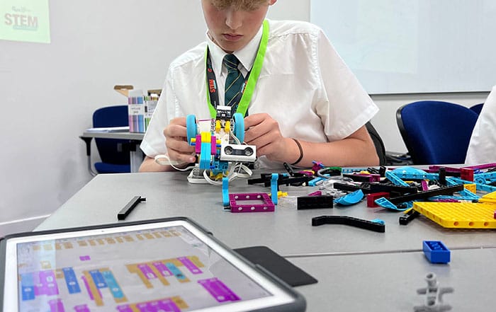 A pupil building a model wheeled ROV out of Lego as part of the GUH STEM Challenge competition.