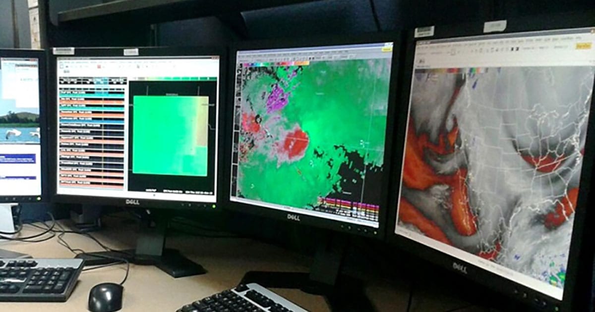 Atmospheric data is displayed on computer screens, part of the Advanced Weather Interactive Processing System (AWIPS) used by meteorologists at NOAA's National Weather Service.