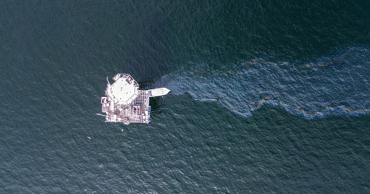 An oil sheen flows in the water during a spill from an offshore drilling platform near Galveston, Texas.