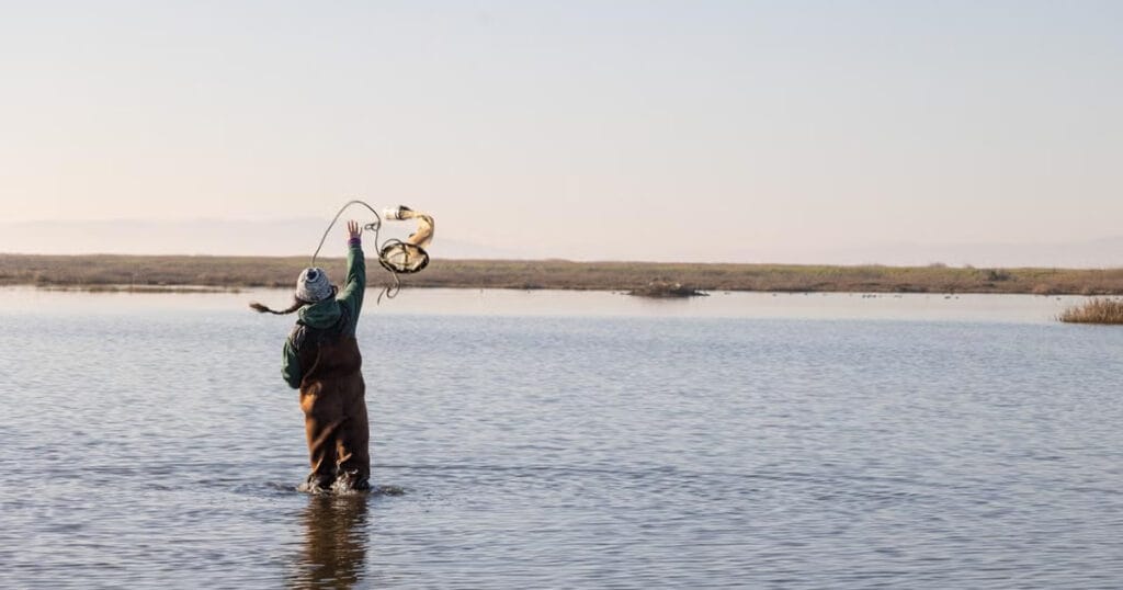 Lynette Williams-Duman of UC Davis Center for Watershed Sciences throws a zooplankton tow-net in Grizzly King, a 175-acre managed wetland in Suisun Marsh.