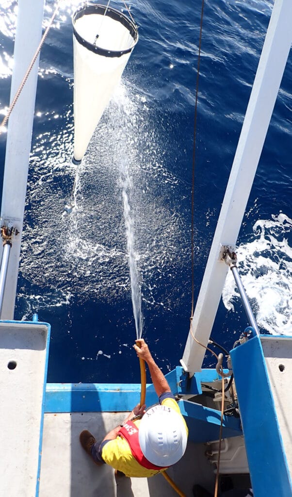 A plankton net is lifted from the water during sampling on the Great Barrier Reef.
