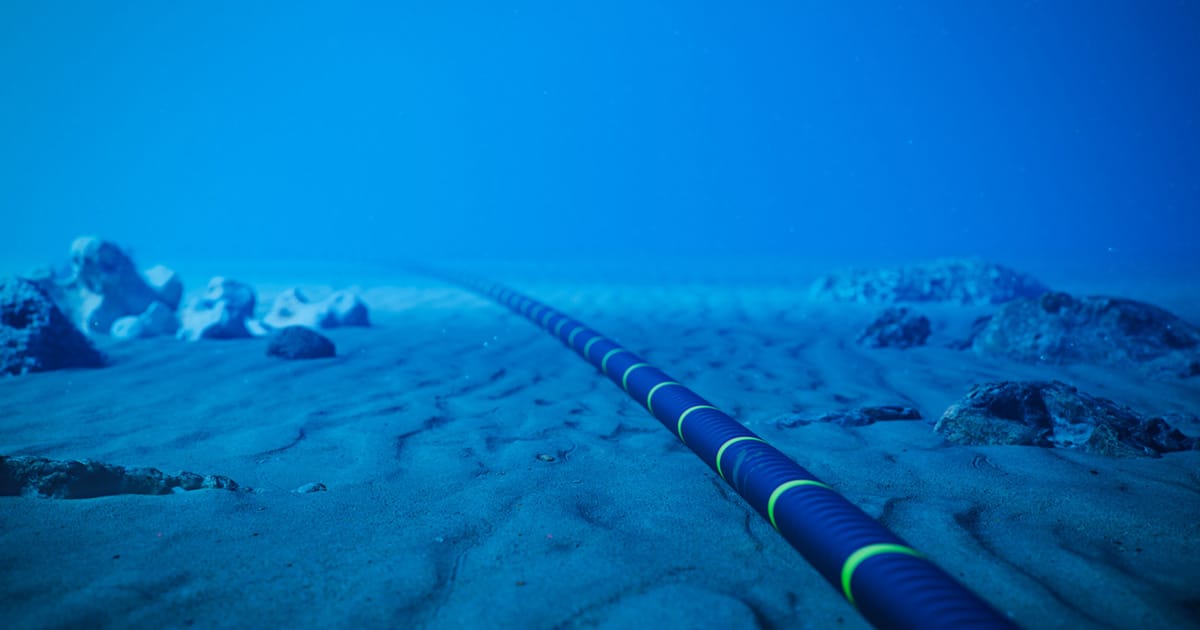 Underwater fiber-optic cable on ocean floor.