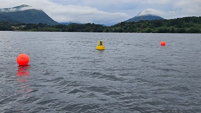 An XB-200 data buoy being deployed by hand from a small vessel. 