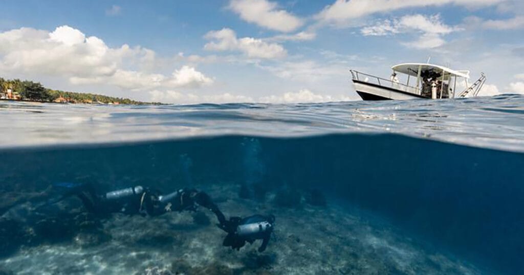 Scuba divers departing for a dive in Nusa Penida, Indonesia.