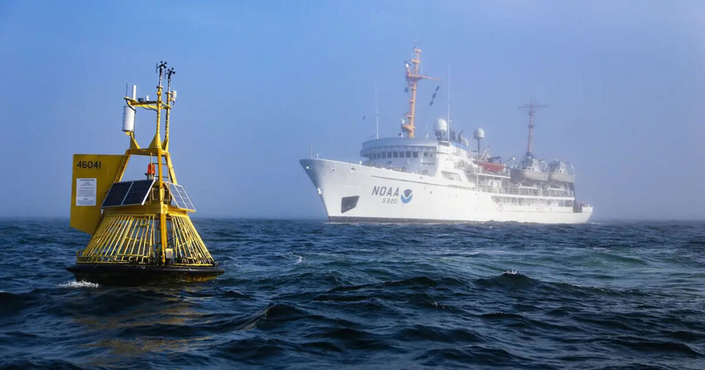 NOAA Ship Ronald H. Brown during the 2021 West Coast Ocean Acidification research cruise with a NOAA mooring measuring ocean chemistry in the foreground.