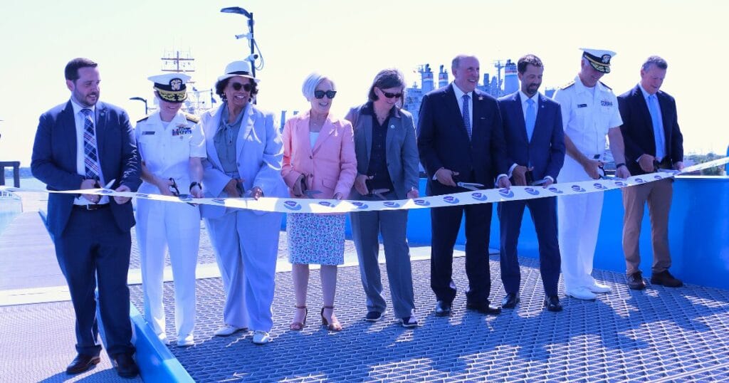 Commerce Department Deputy Secretary Paul Dabbar and NOAA Administrator Neil Jacobs, Ph.D., (fourth and third from the right, respectively) joined other leadership and partners to cut a celebratory ribbon draped across the entrance to NOAA’s newest pier and port facility in Charleston, South Carolina, July 8, 2026. (Image credit: NOAA)