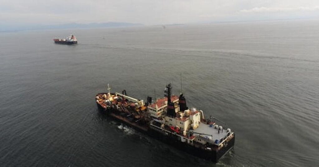 Aerial photograph of two dredging vessels at the Columbia River mouth. (Image credit: USGS)