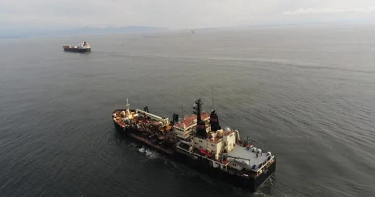 Aerial photograph of two dredging vessels at the Columbia River mouth. (Image credit: USGS)