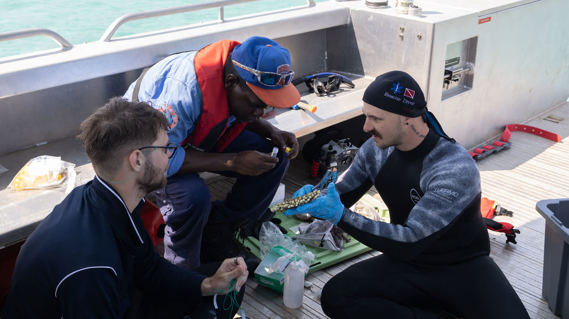 Researchers Dane Wattle and Dr Hadley England show Annindilyakwa rangers how to sample corals for genetics. (Image credit: Annabelle Doheny)