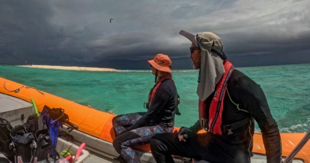 Survey team navigates approaching storm during reef monitoring fieldwork. (Credit: LTMP)