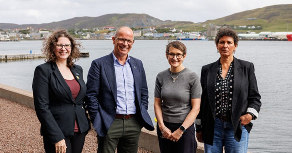 Jim Fairlie MSP, Minister for Agriculture, Marine and the Islands; Dr Beth Mouatt, UHI Dean of Research and Innovation; and Michele Kerry, Shell-volution Project Manager outside UHI Shetland Scalloway campus. (Image credit: UHI and Ben Mullay)