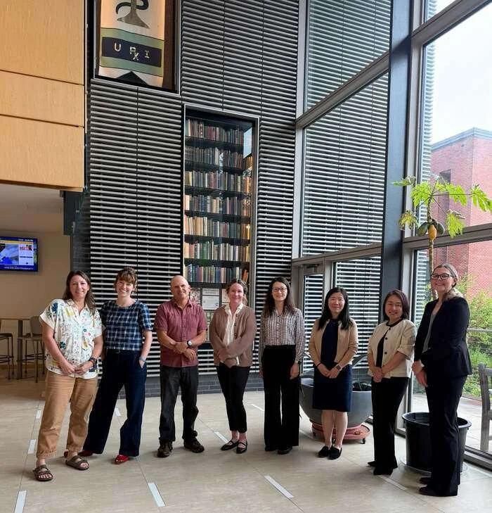 URI's Ying Zhang (fourth from right) is leading a project to advance wetland resilience across coastal systems with colleagues in Rhode Island and beyond (left to right): Kris Lewis, Erin Peck, Kenneth Raposa, Jaclyn Witterschein, Zhang, Hui Zhou, Emi Uchida, and Julia Wyman. (Not shown, Michael Pürrer). (Image credit: Anna Gray, URI)