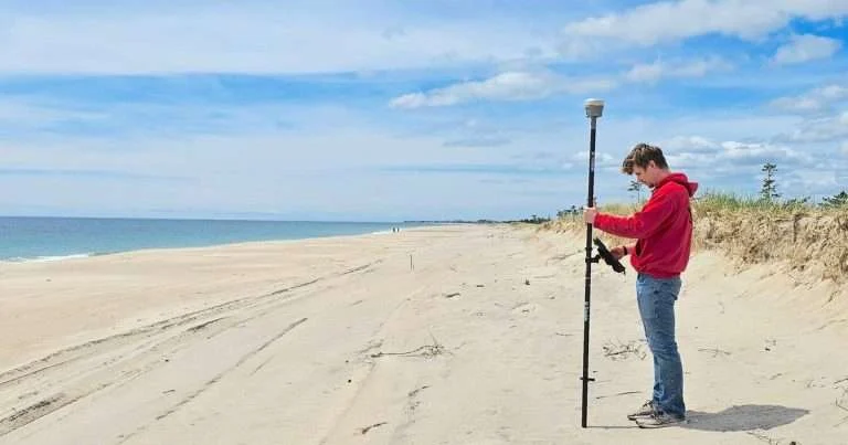Student Jake Harrington uses real-time kinematic global positioning system for a beach survey. (Image credit: J.P. Walsh, URI)
