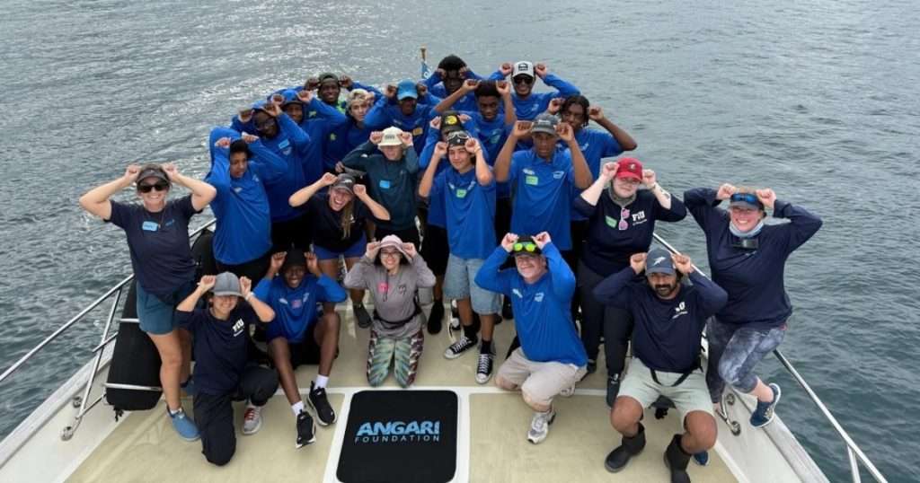 Inlet Grove Community High School students and educators celebrate a successful catch and release of a great hammerhead shark during their fun day of education and research onboard R/V ANGARI. (Image credit: ANGARI Foundation)