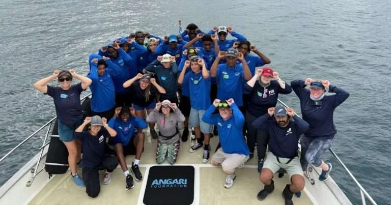 Inlet Grove Community High School students and educators celebrate a successful catch and release of a great hammerhead shark during their fun day of education and research onboard R/V ANGARI. (Image credit: ANGARI Foundation)