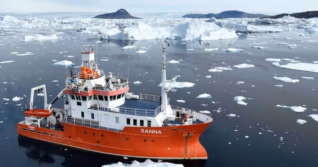 R/V Sanna with Tuttulikassaap Sermia (Hayes Glacier) in the background during the recent expedition. (Credit: Aurora Roth, Harvard/SIO)