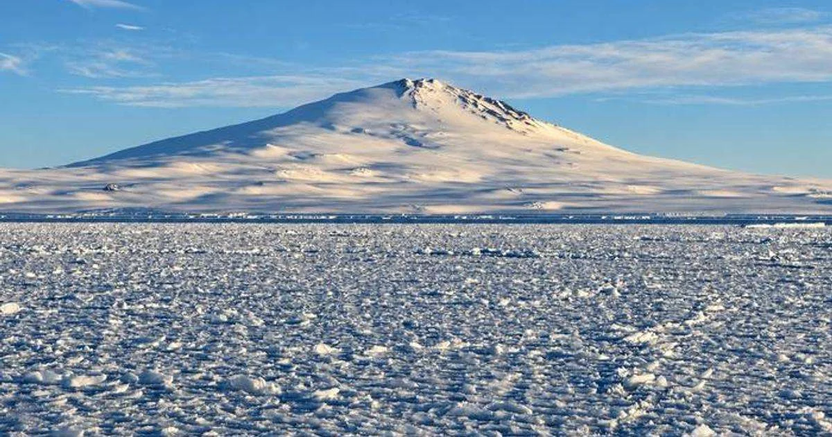 Sea ice off Victoria Land, Antarctica, with Mount Melbourne in the background. (Credit: Alberto C Naveira Grabato)