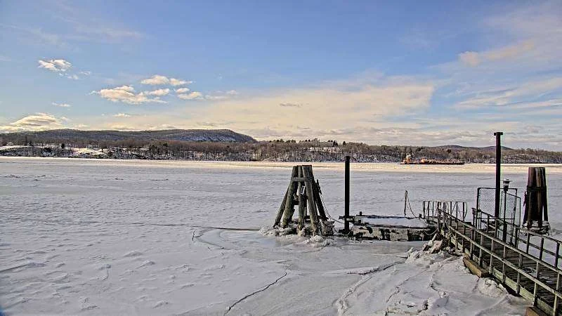 View from the webcam at the Norrie Point Environmental Center on February 12, showing a frozen river, and on September 8, with the docked river pilot boat. (Credit: IOOS Association)