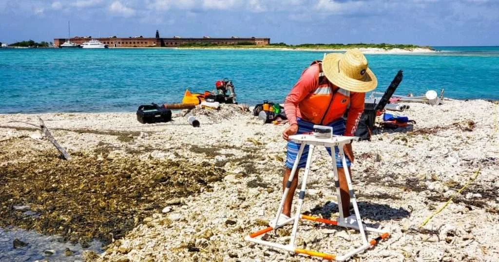 SPCMSC scientist Anastasios Stathakopoulos performs surveys on the coral-rubble keys in Dry Tortugas National Park. View is looking west from Long Key with Fort Jefferson in the background. (Image credit: USGS)