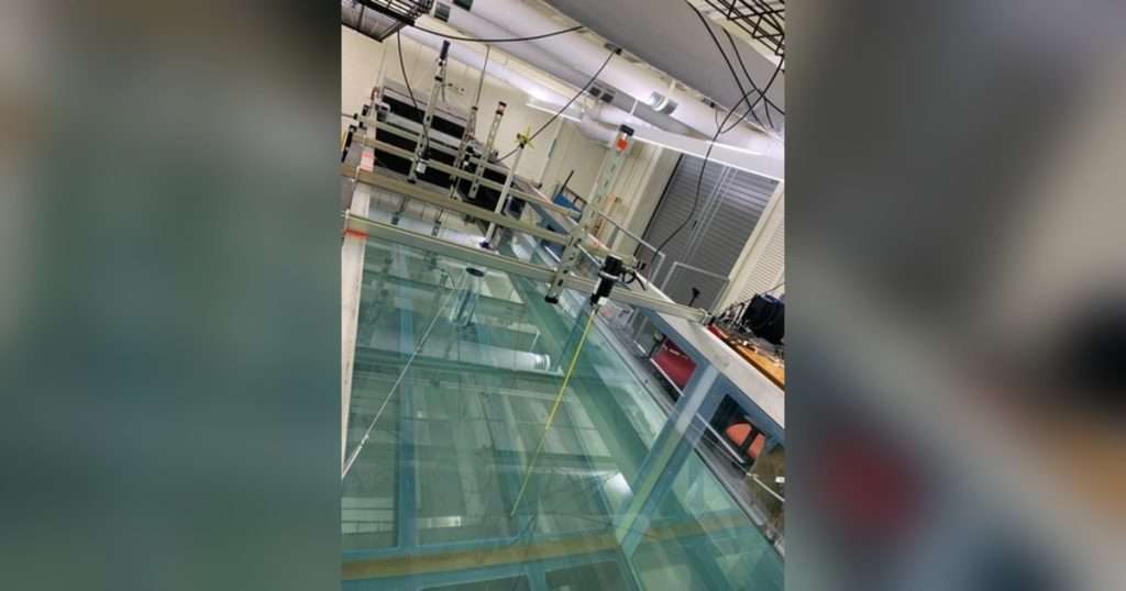 A wave flume with a wind turbine spar in the UMass Amherst Ocean Resources and Renewable Energy Group lab. Top: Aerial view of the Bartholomew Gosnold Monument on Cuttyhunk Island (Credit: Creative Commons/John Phelan).