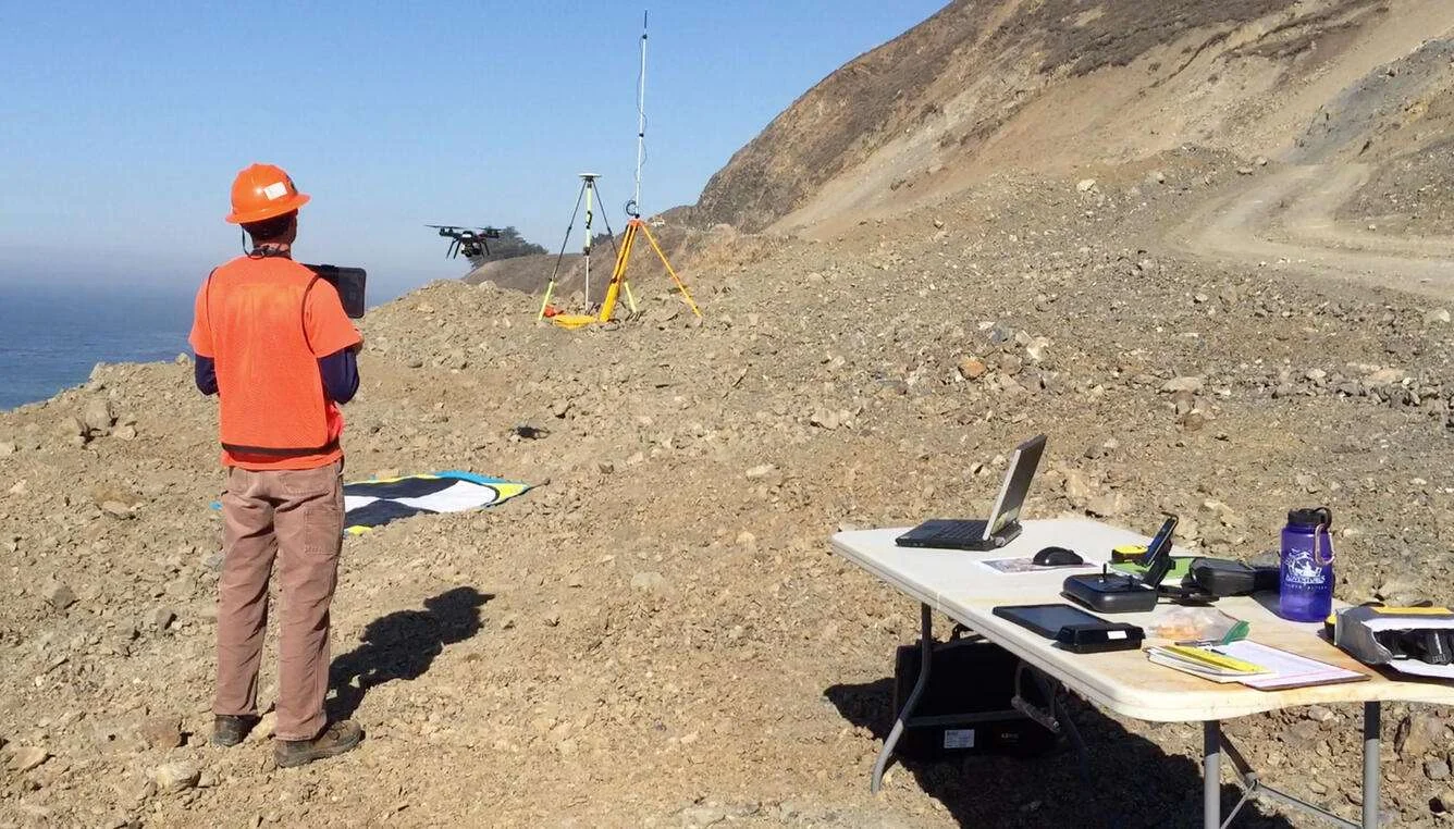 Josh Logan, a physical scientist at the USGS Pacific Coastal and Marine Science Center in Santa Cruz, California, operates an unmanned aerial system, or UAS, to collect imagery of the Mud Creek landslide on the coast of Big Sur in May 2017. (Image credit: USGS)